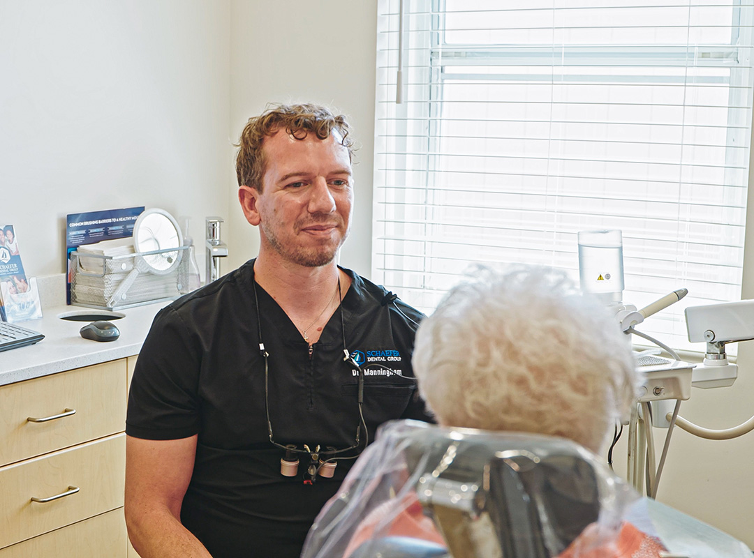 Dr. Louison Manningham speaking with a patient at Schaefer Dental Group in Brighton, MI.