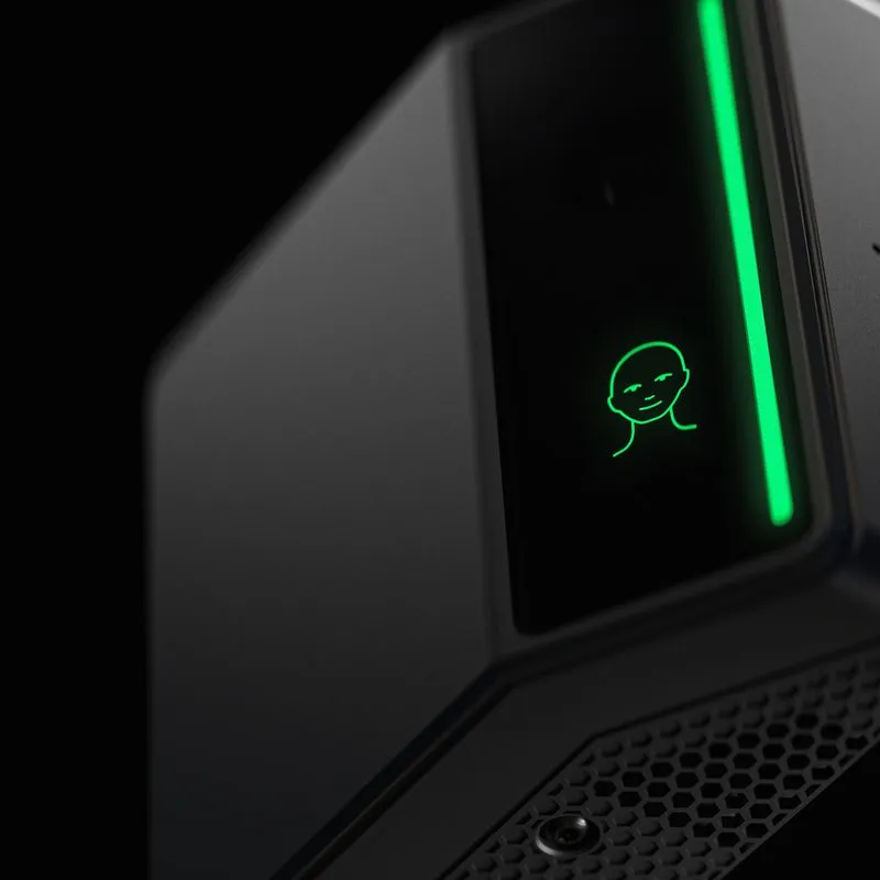 Close-up of the Rock X biometric access control device, its dark housing lit by a green vertical light strip and a glowing face-scan icon