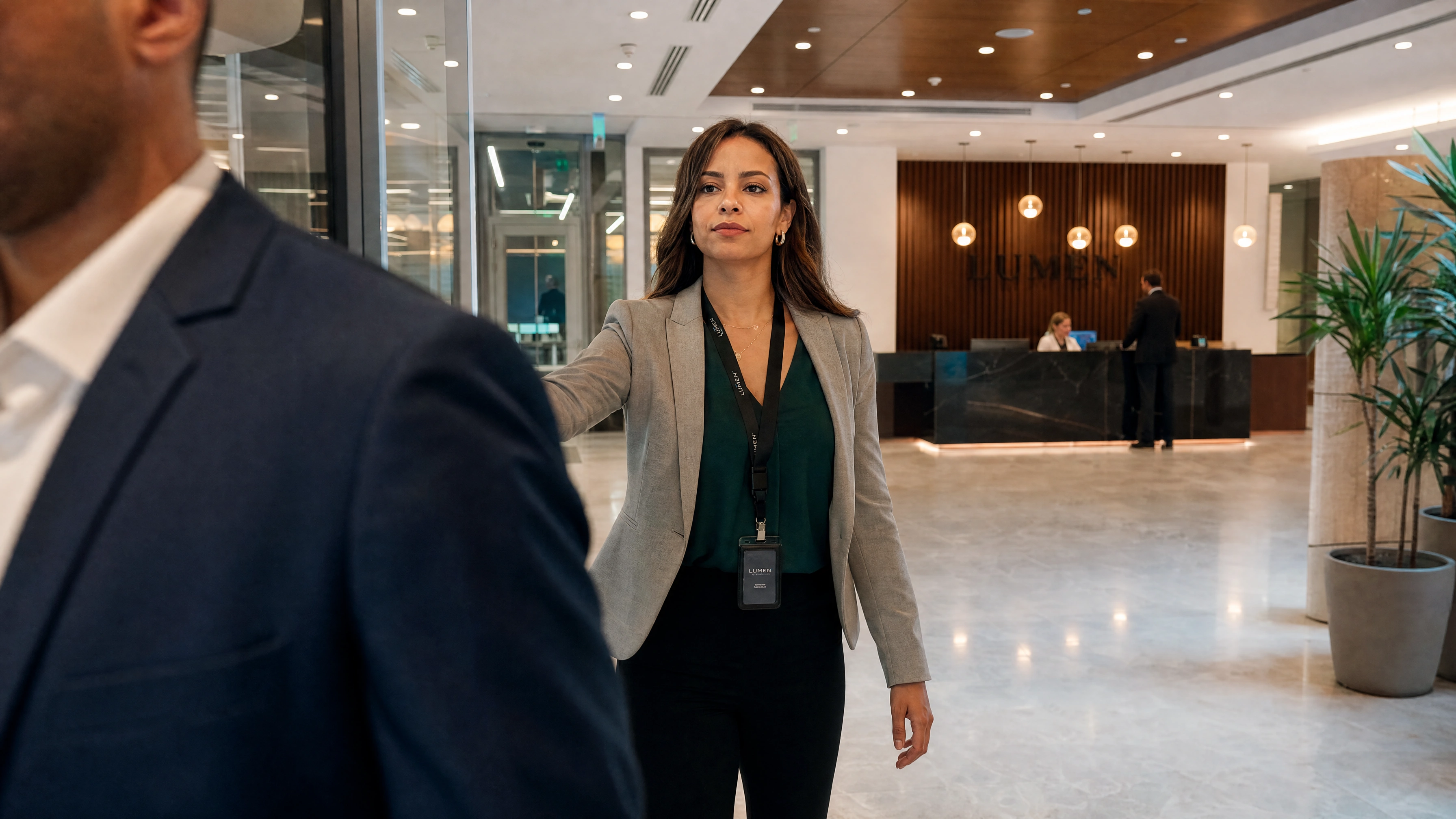 An employee crossing a corporate lobby past the reception desk