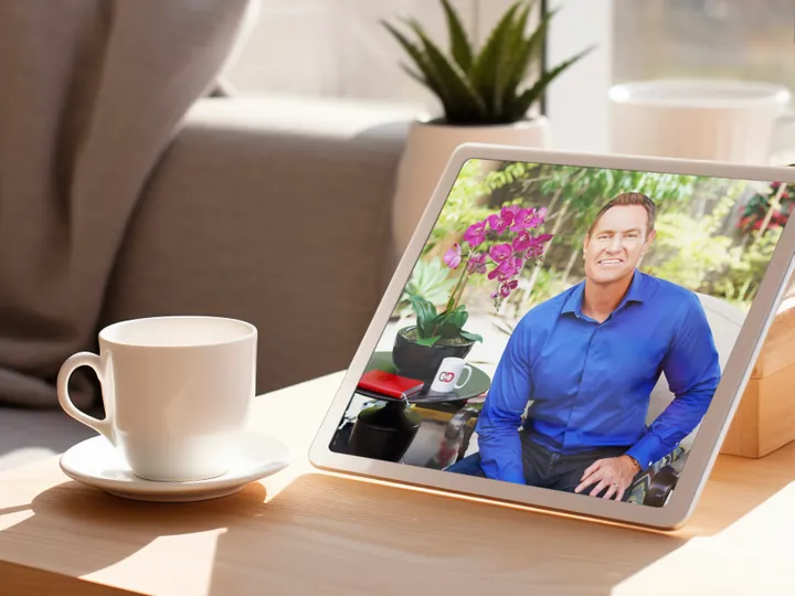 DarrenDaily playing on a tablet beside a morning coffee