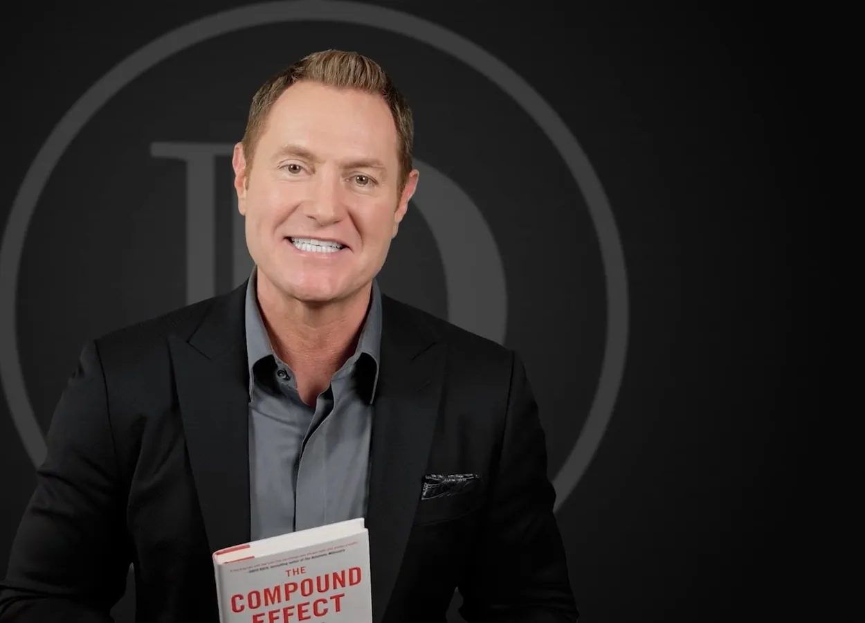 Darren Hardy holding The Compound Effect