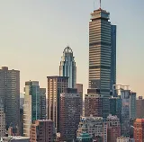 City skyline with tall office towers in soft evening light