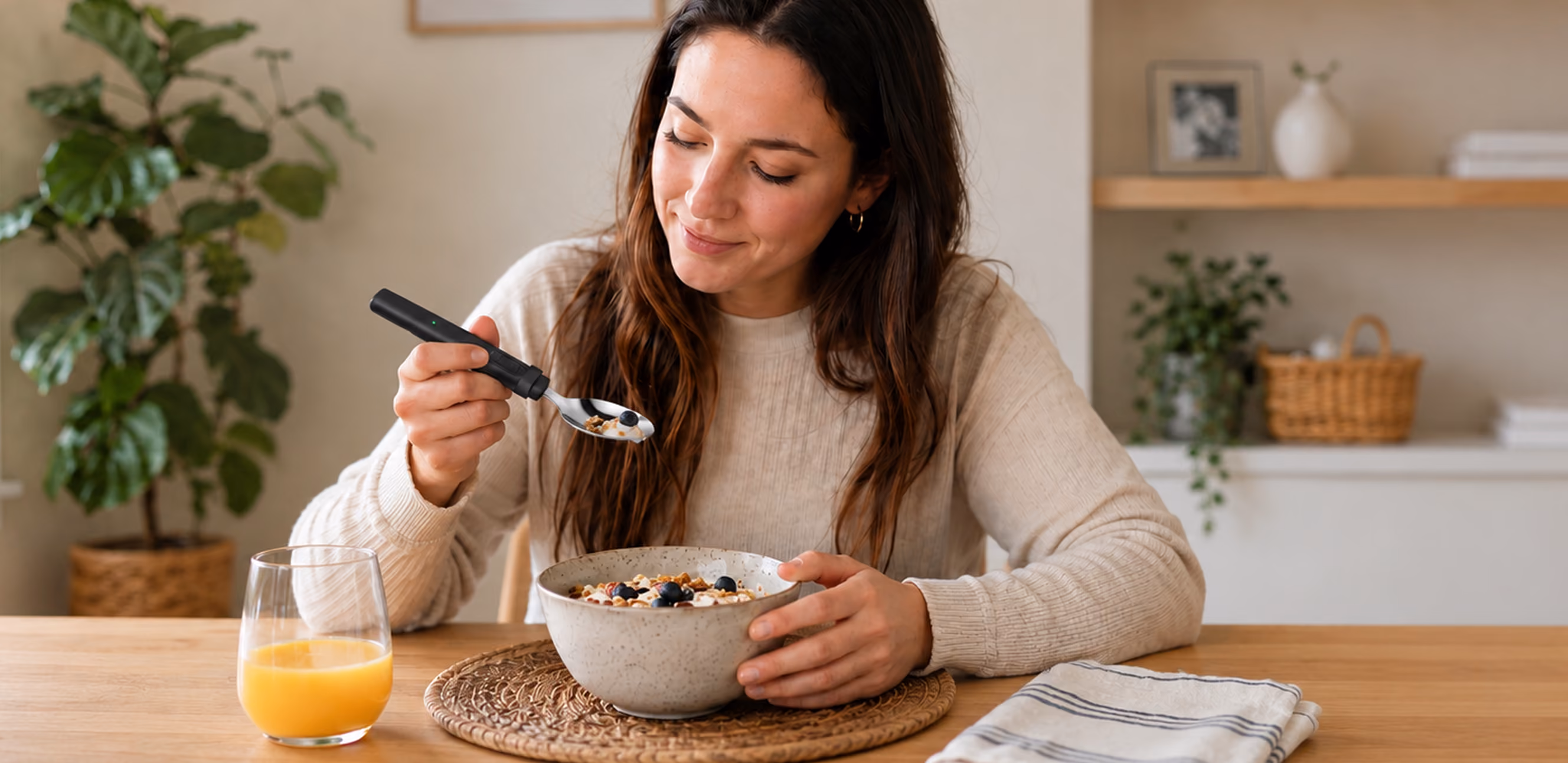 Woman eating from a bowl with a BiteQ spoon