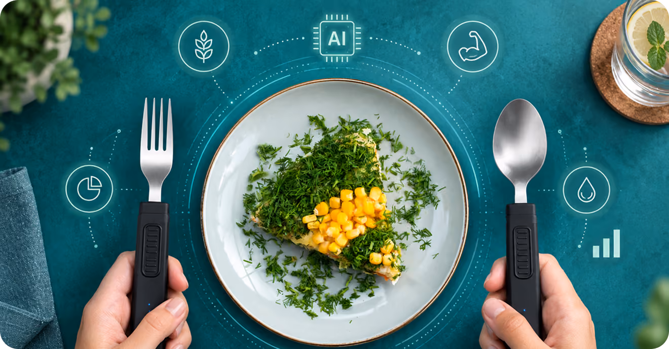Two hands using a BiteQ fork and spoon over a plate of food
