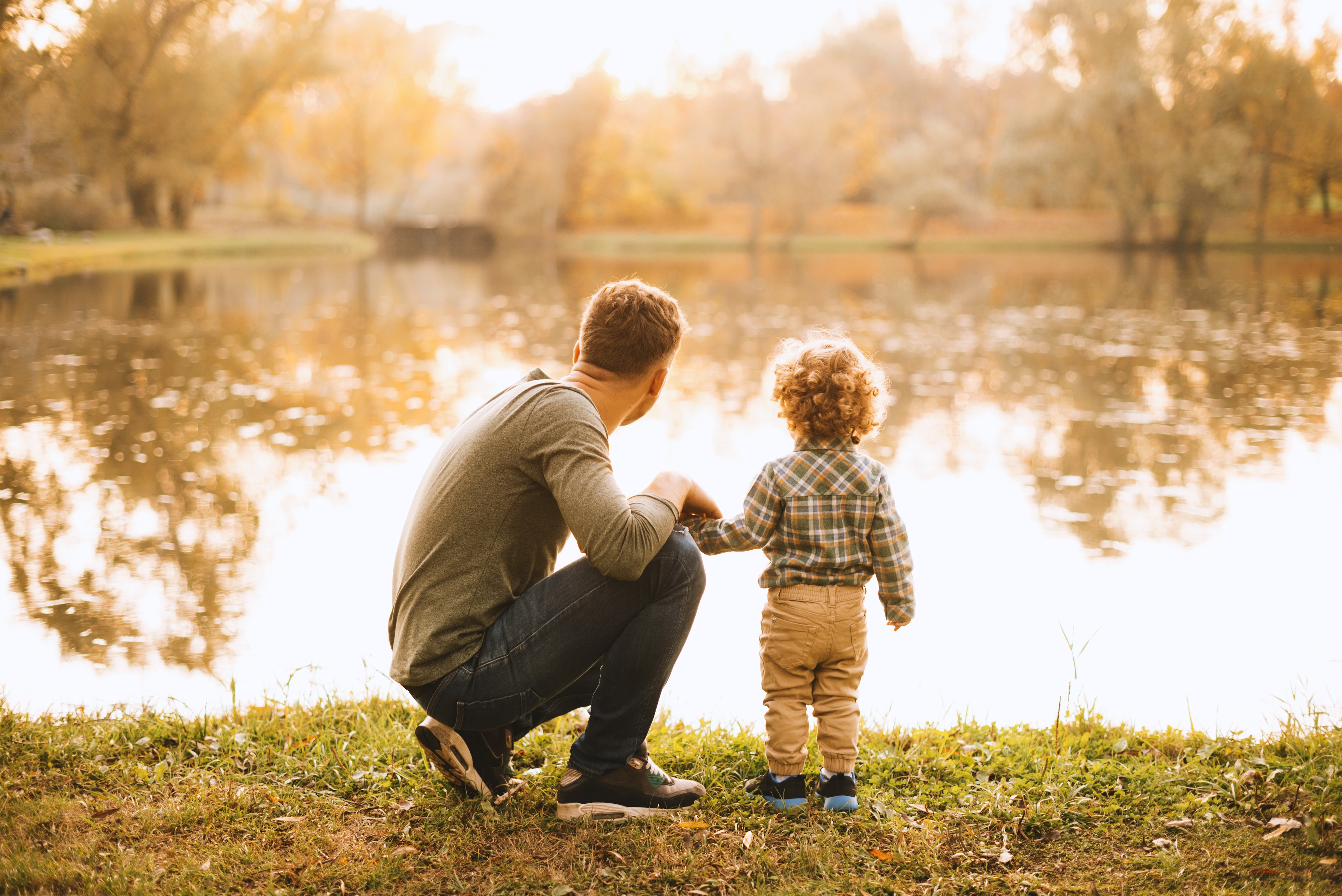 Man and son standing at the water's edge stock image