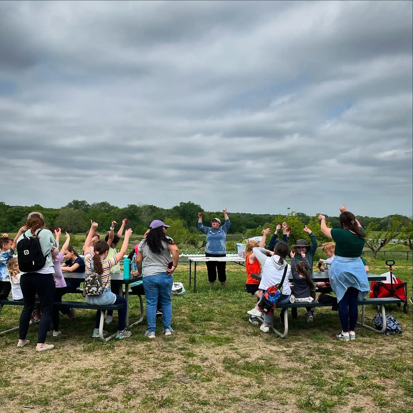 Visitors gathered at picnic tables at Pure Land Farm