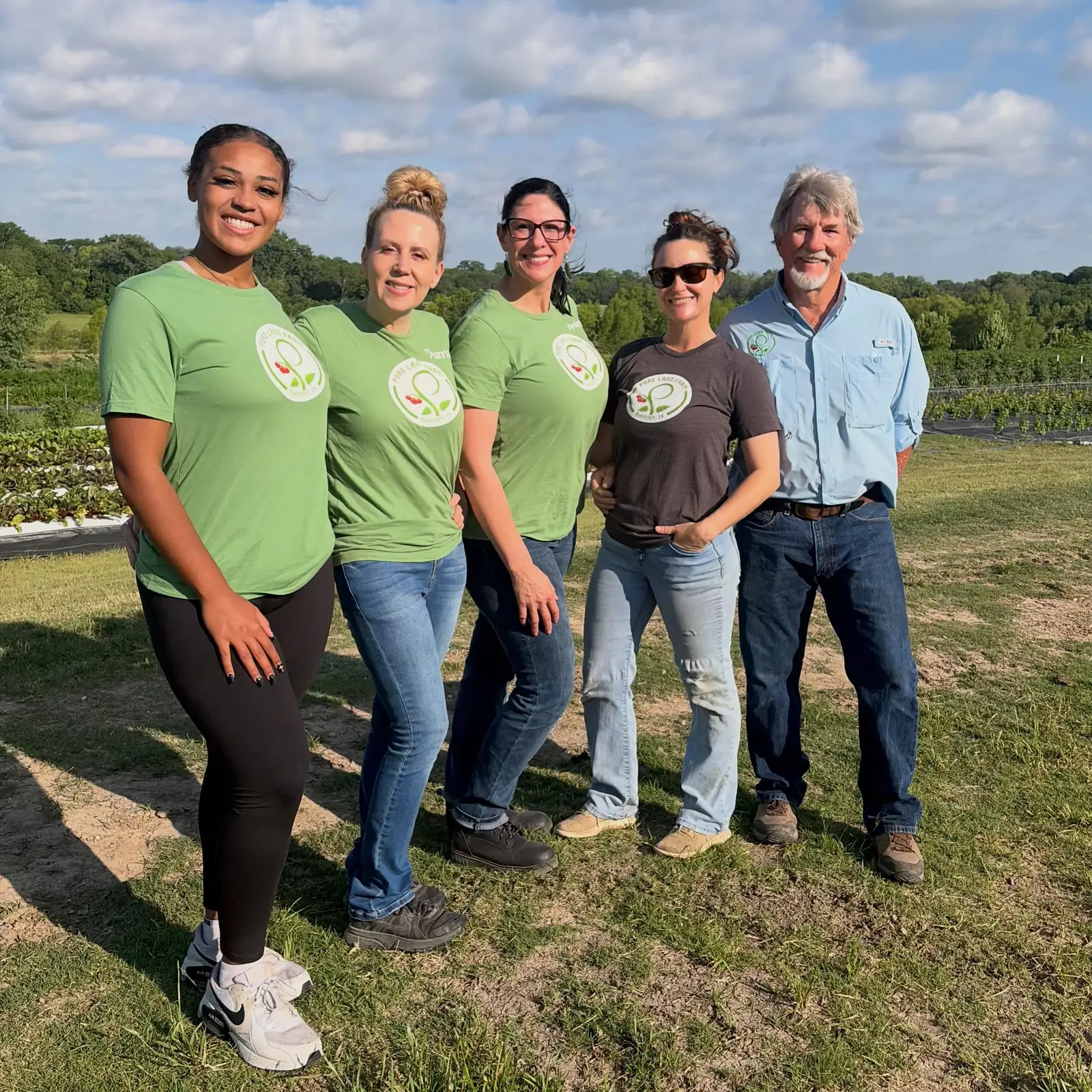 The Pure Land Farm team standing in the field in McKinney, Texas