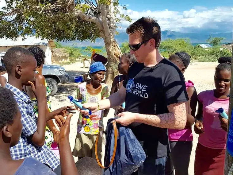 Brock Frost in Haiti handing out water supplies
