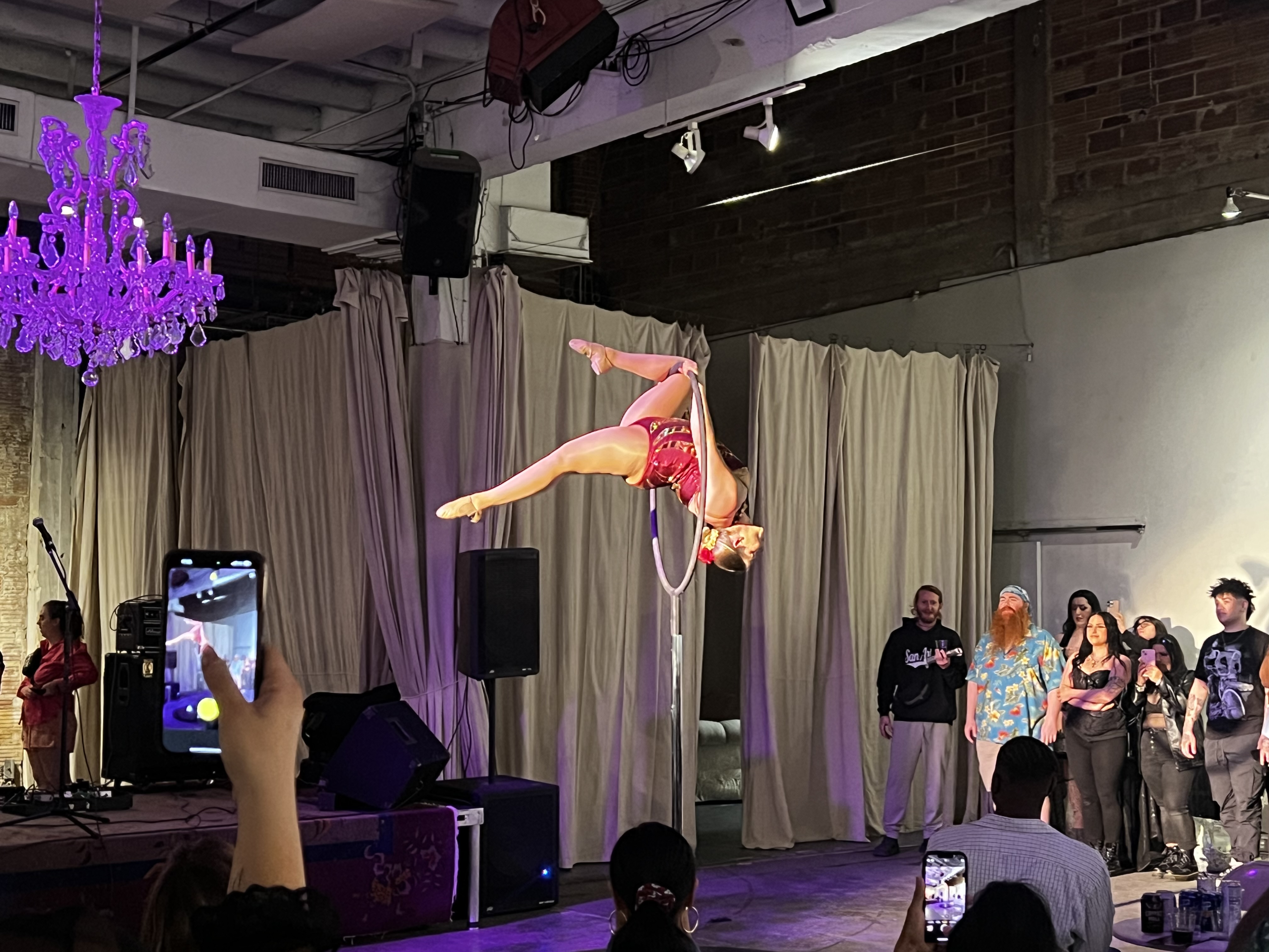 An aerial performance above the audience in the main hall at 108 Blue Star