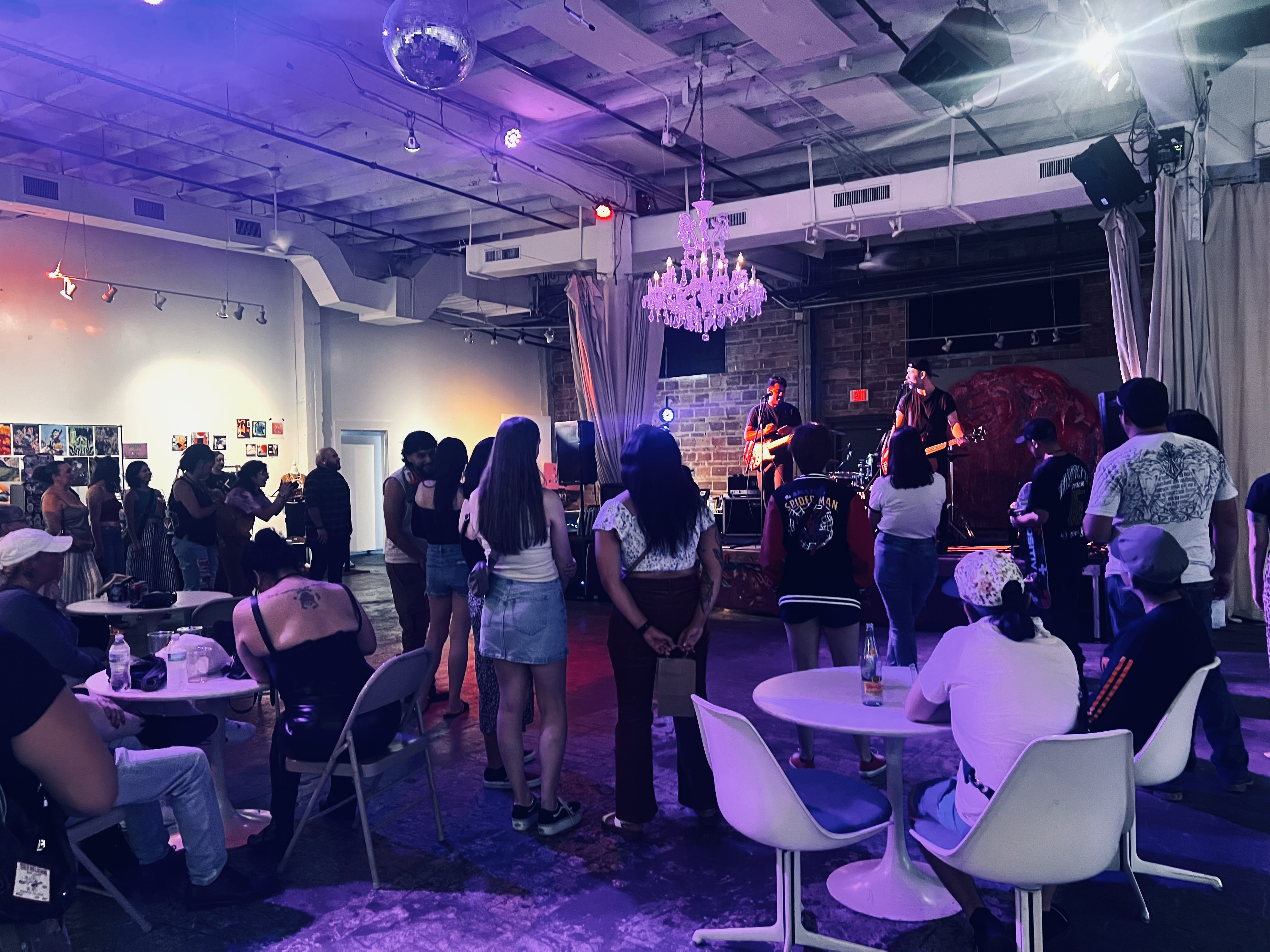 A live music night at 108 Blue Star, with guests at tables in front of the band