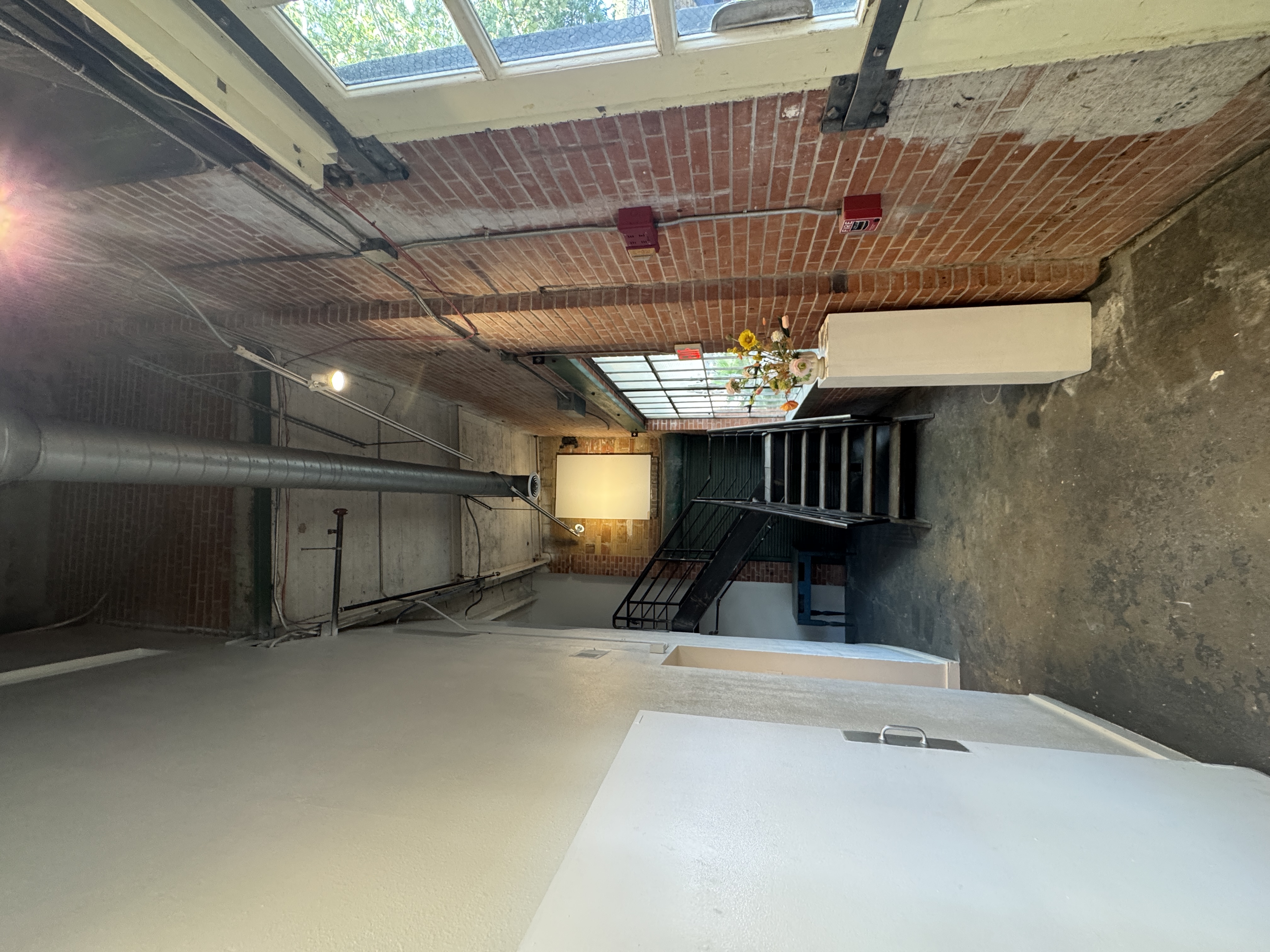 The entry hall at 108 Blue Star, with brick walls and the stairs