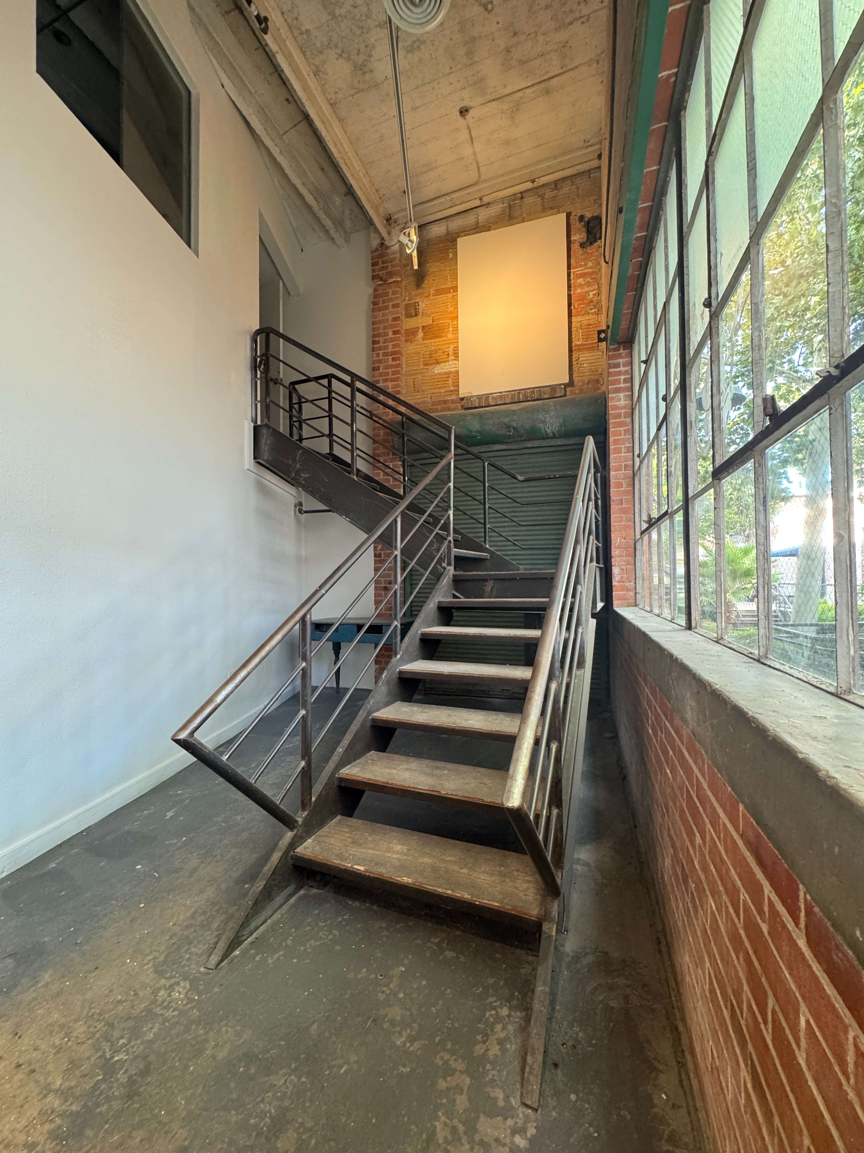 The stairs at 108 Blue Star beside the tall window wall