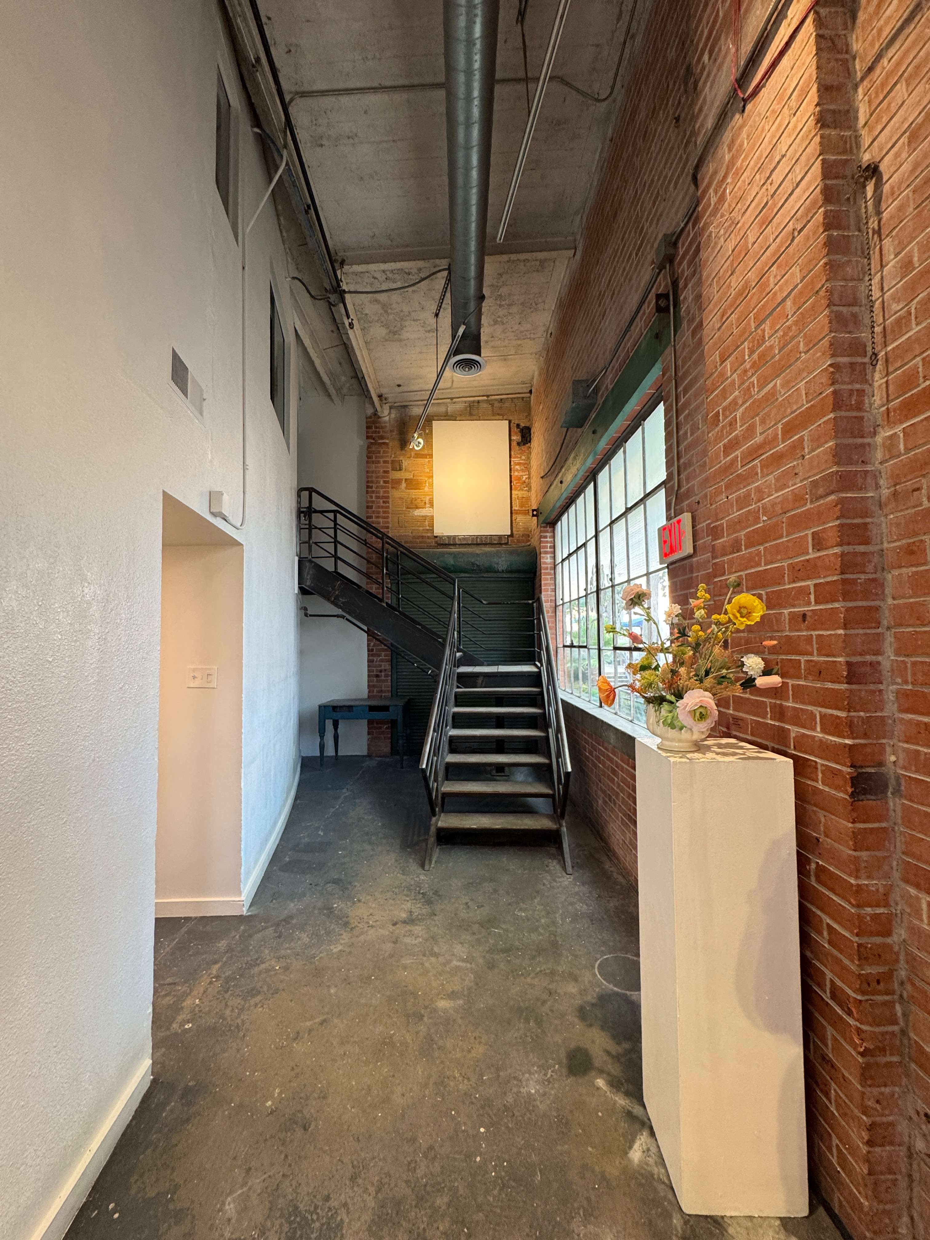 The entry hall at 108 Blue Star, with a flower arrangement on a pedestal