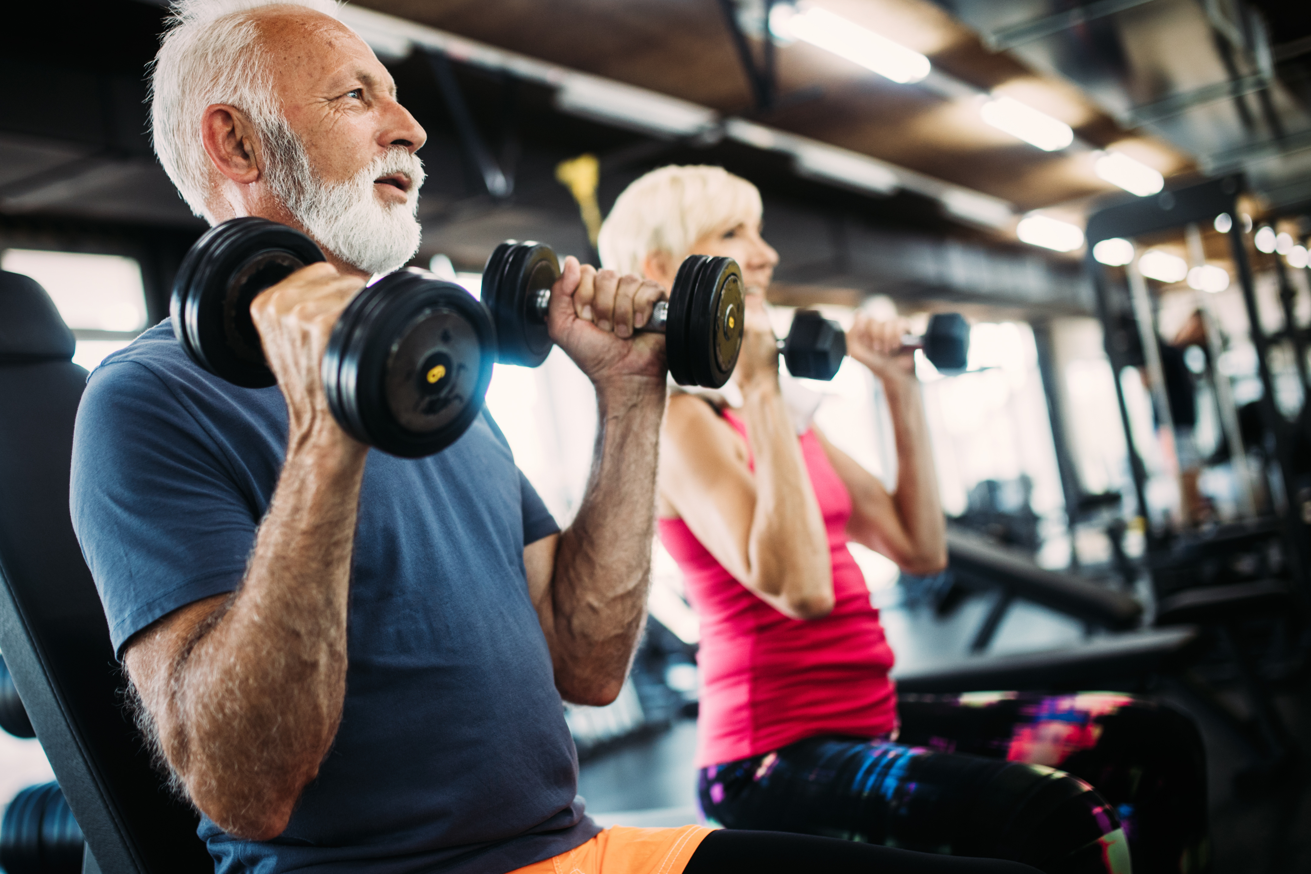 Senior man and woman working out stock image