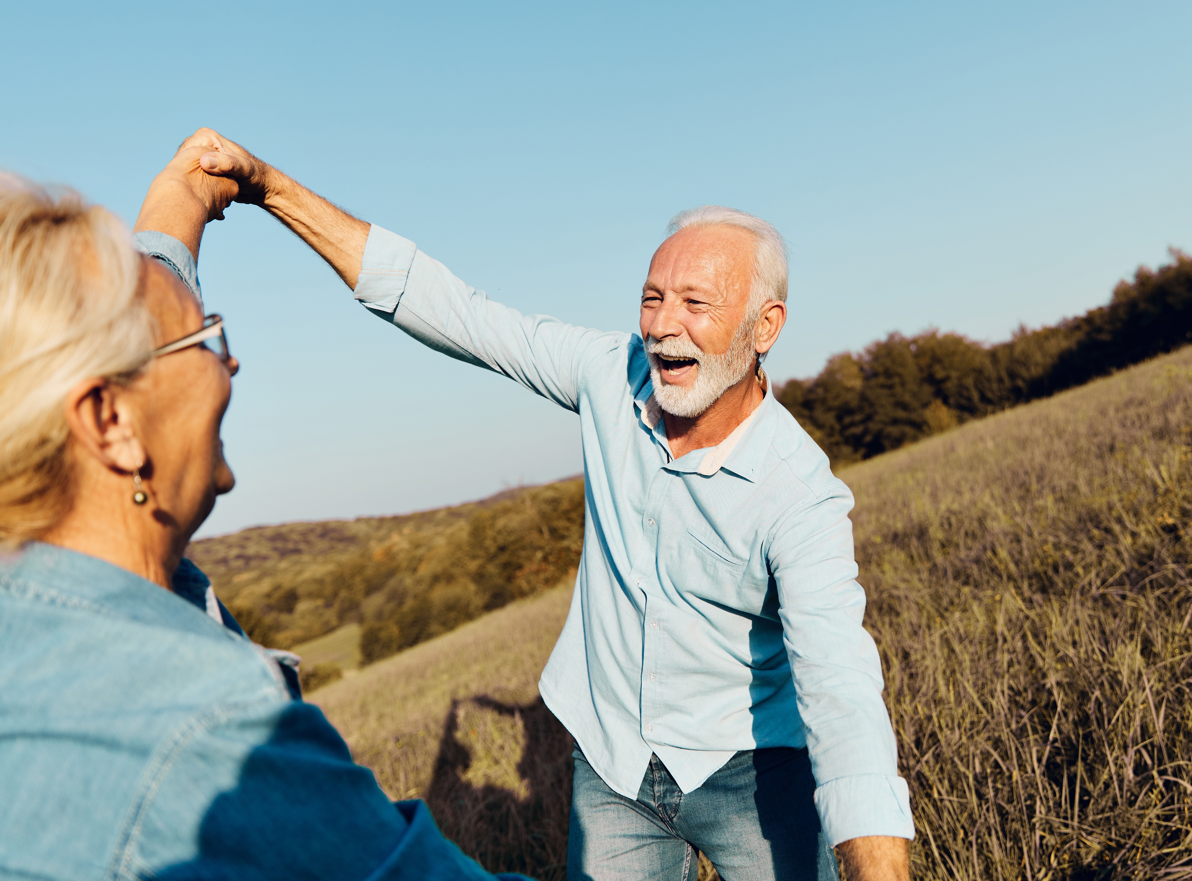 Senior man and woman standing in a field stock image