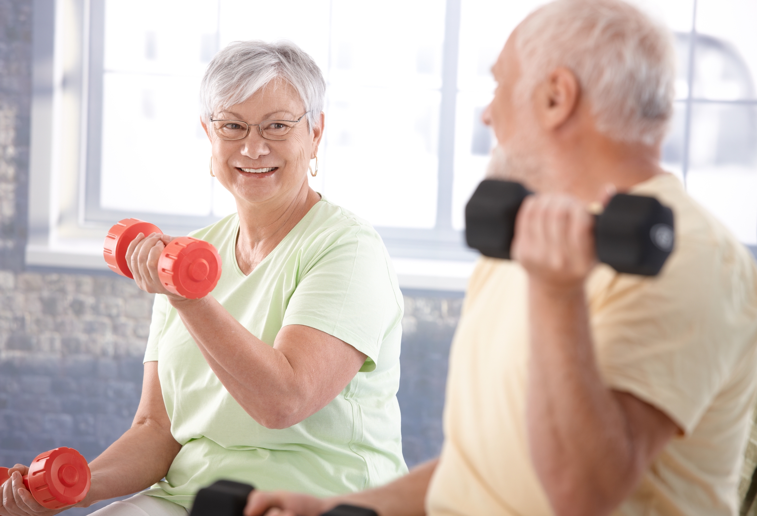 Senior man and woman working out stock image