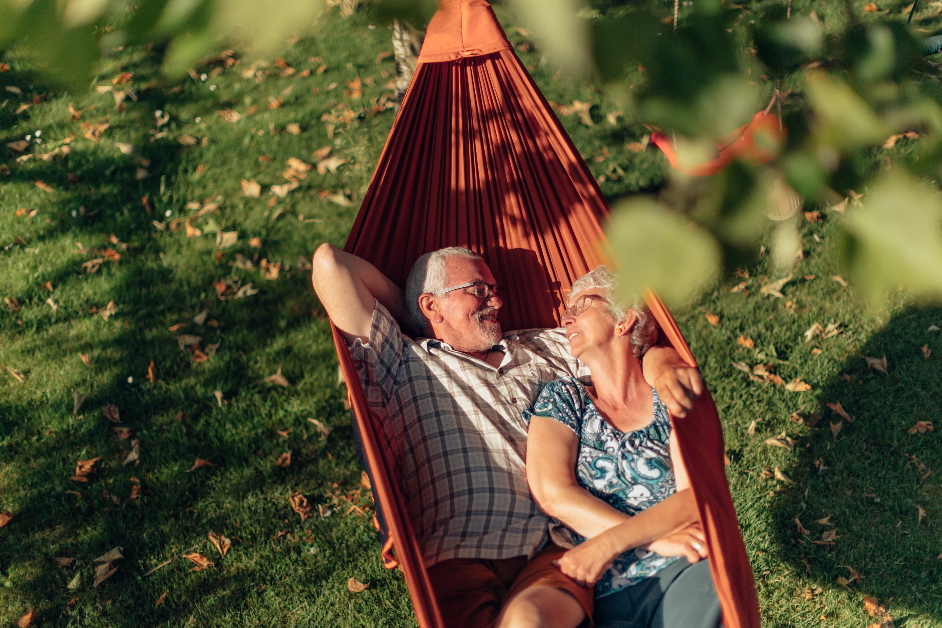 Senior man and woman laying in a hammock stock image