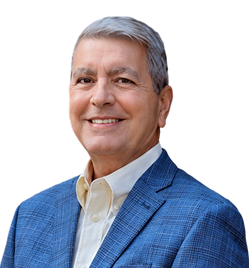 Smiling middle-aged man with gray hair wearing a blue checkered blazer and light-colored shirt against a white background.