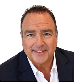 Middle-aged man with short dark hair and a warm smile wearing a blue striped shirt and dark blazer against a white background.