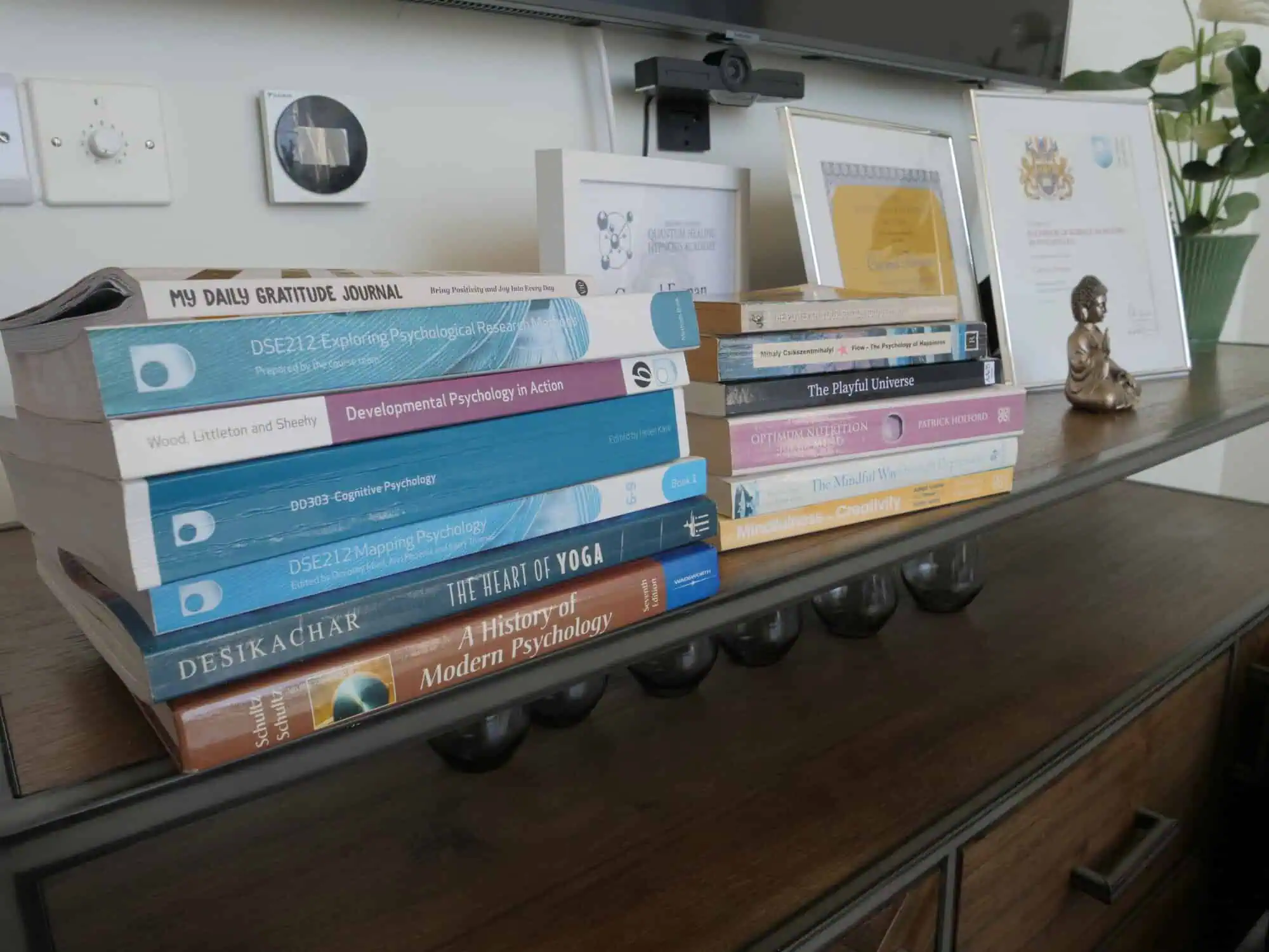 Accredited psychology degree certificate displayed with academic textbooks highlighting professional expertise.