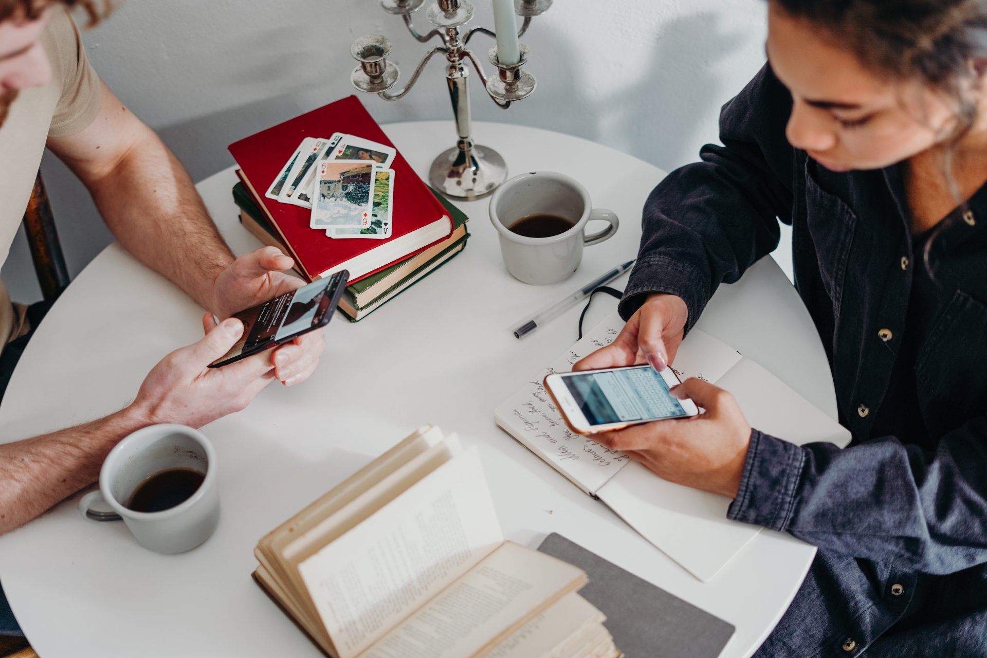 Unhappy divorced couple texting each other at dining table