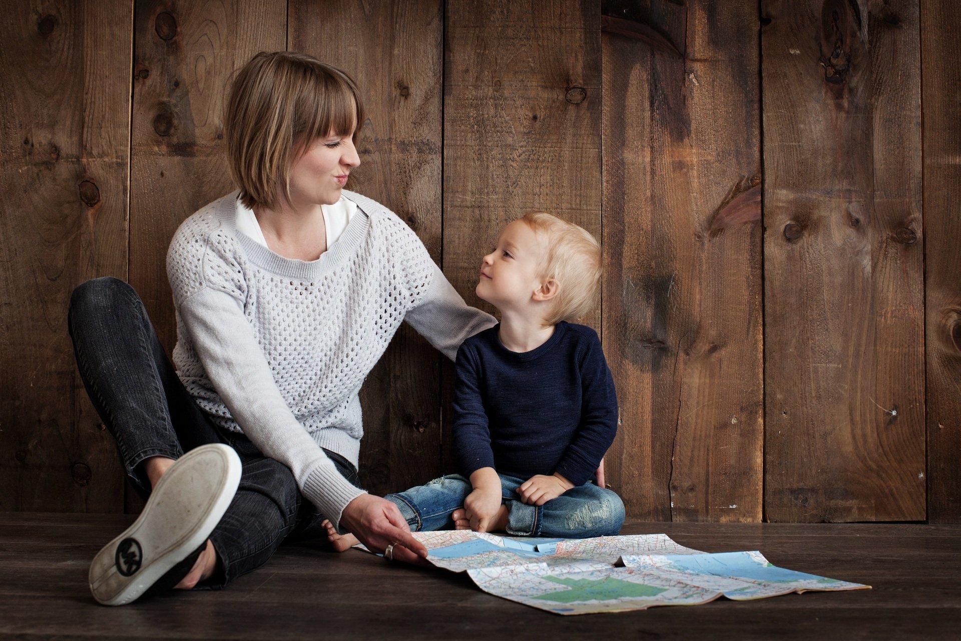 Child and guardian playing with a map