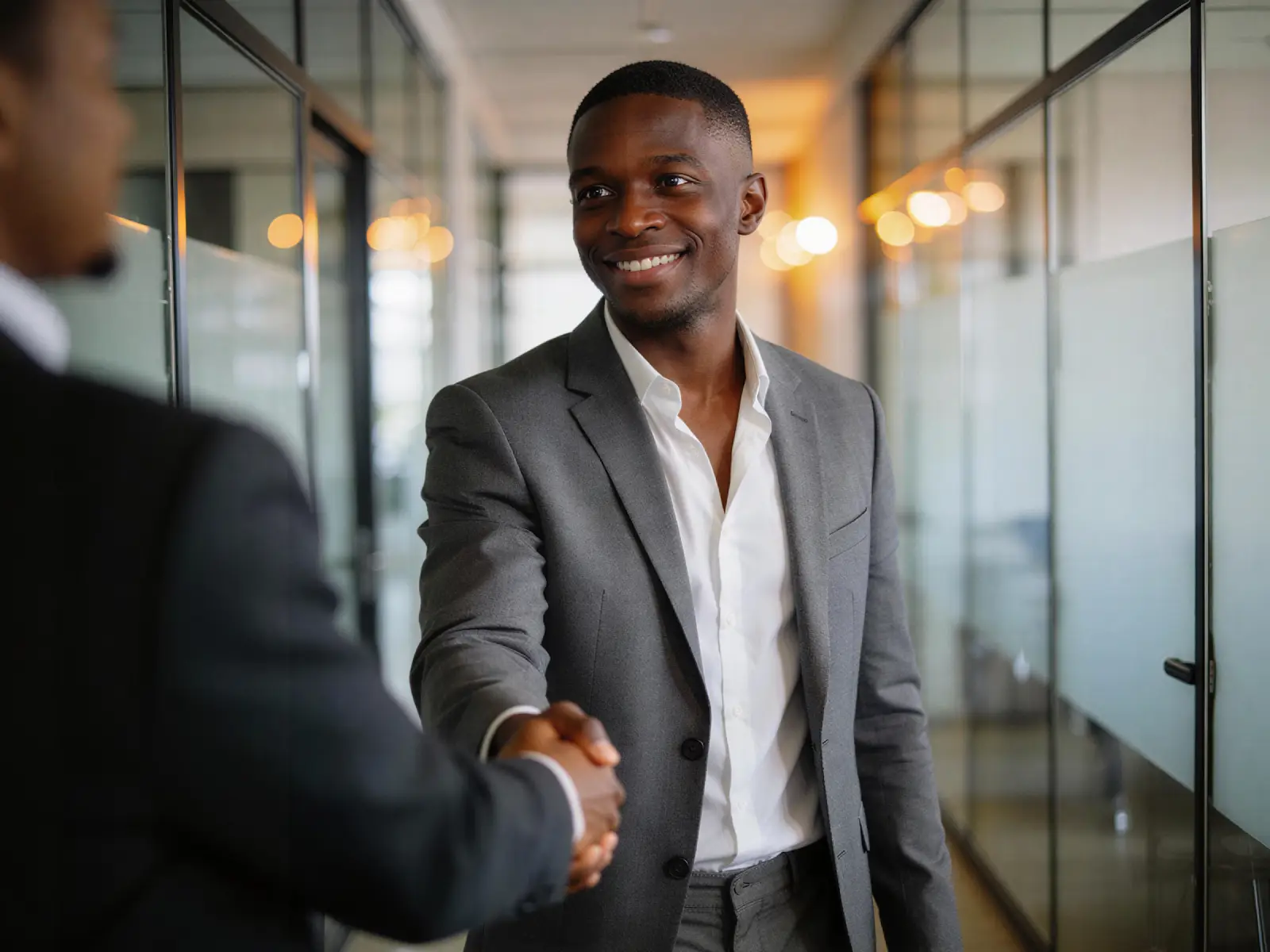 Two professionals shaking hands in agreement