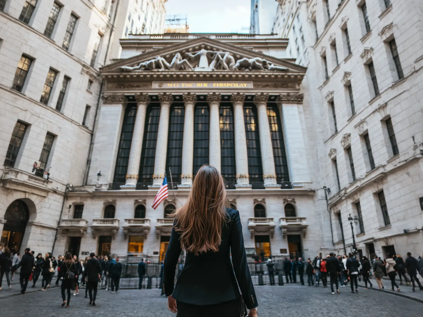 A person standing in front of a classical courthouse building
