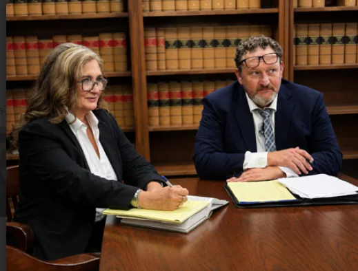Frank Carter and Anna Marie Carter reviewing a case at the firm's office