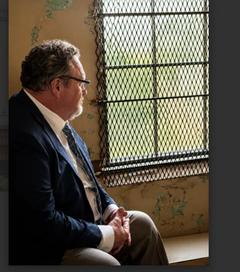 Attorney Frank Carter looking out a window