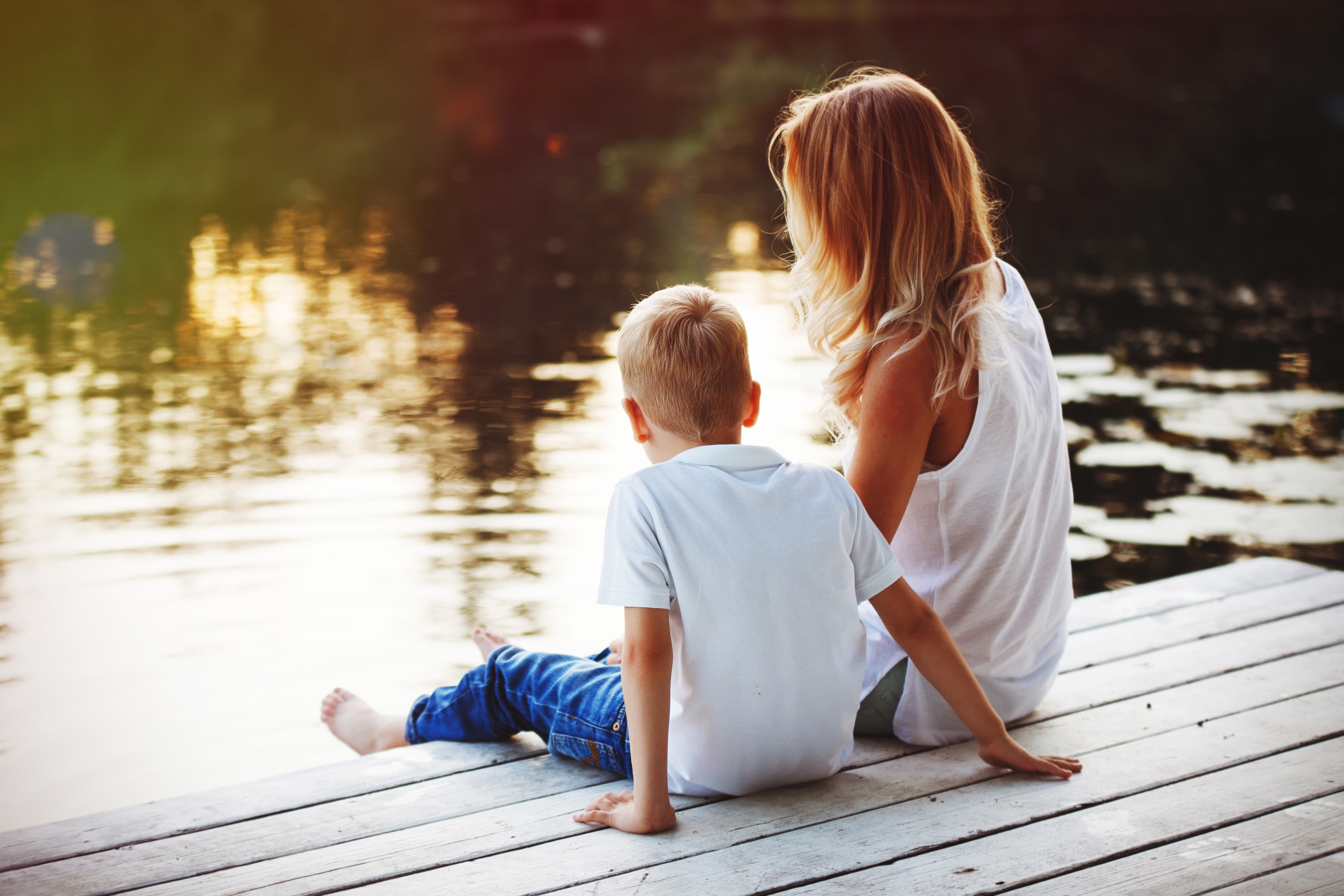 Woman and child on a dock by the lake stock image