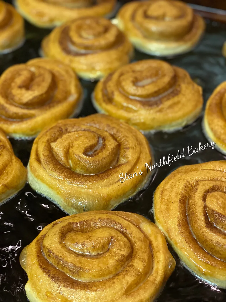 Cinnamon rolls frying in the bakery's fryer