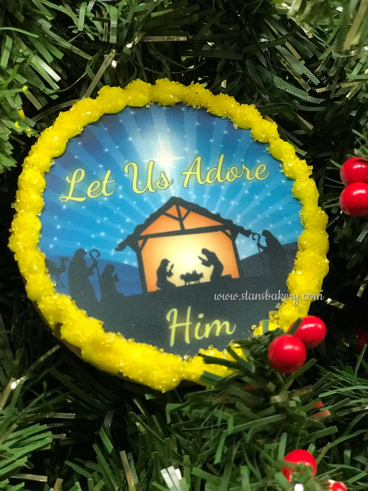 A nativity cookie lettered Let Us Adore Him