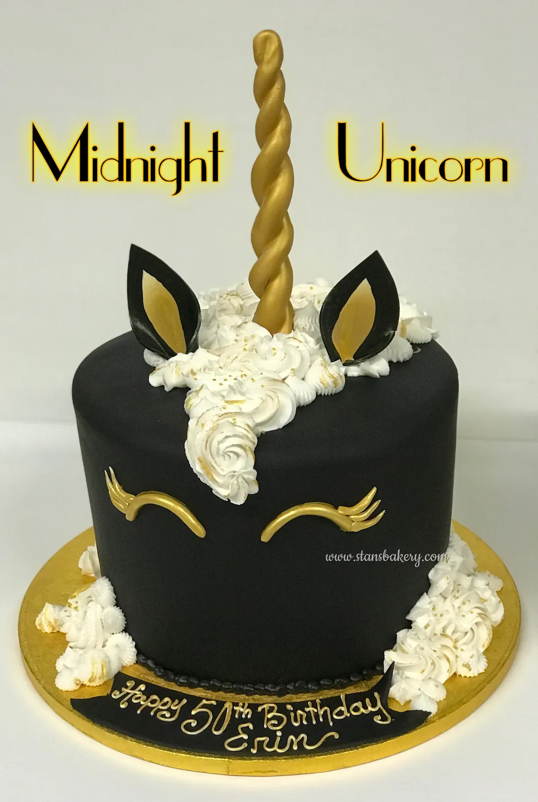 A black unicorn cake with a gold horn
