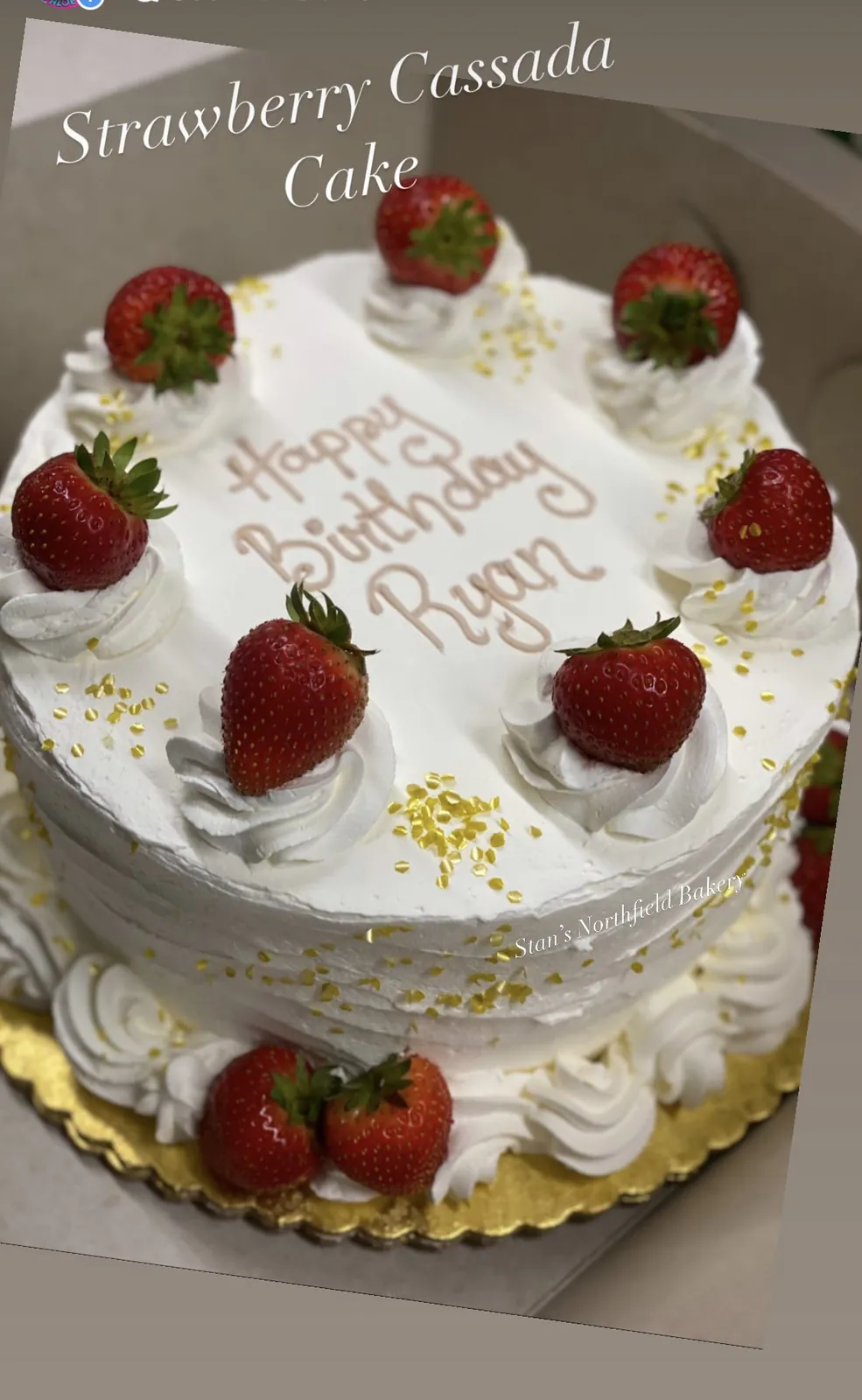 A strawberry cassata cake topped with whole strawberries