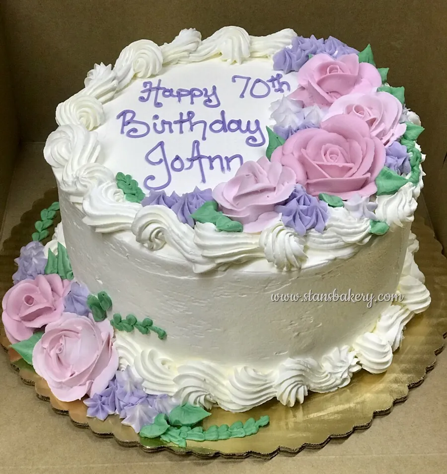 A standard 8-inch round birthday cake with piped roses