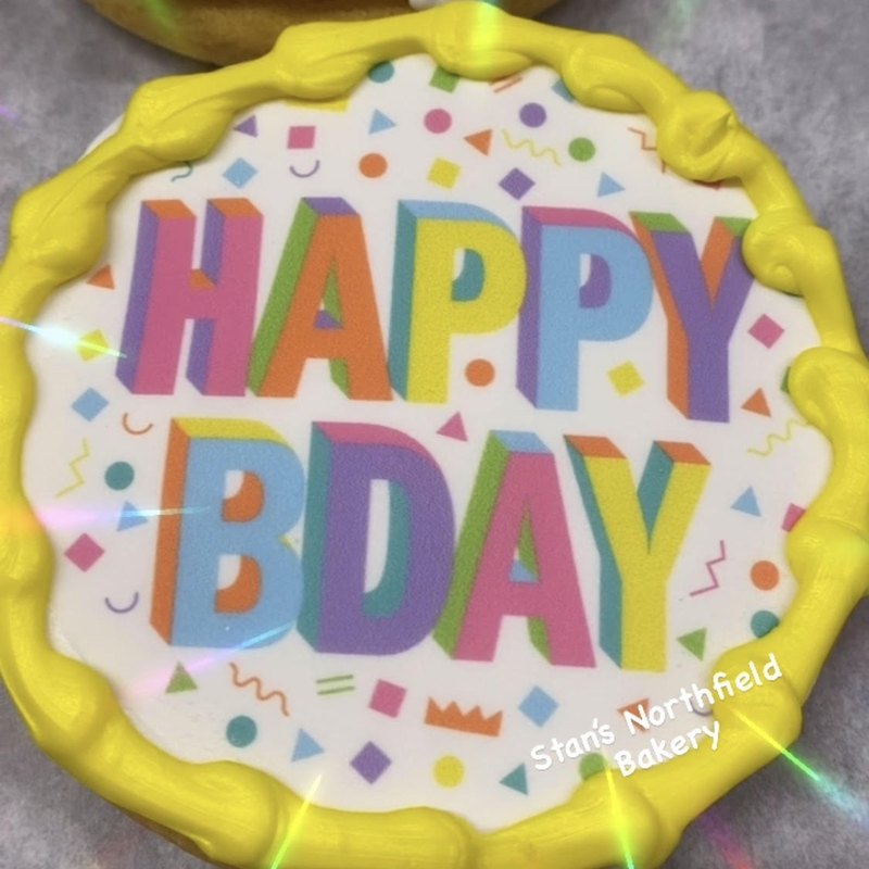 A colorful Happy Birthday edible-image cookie