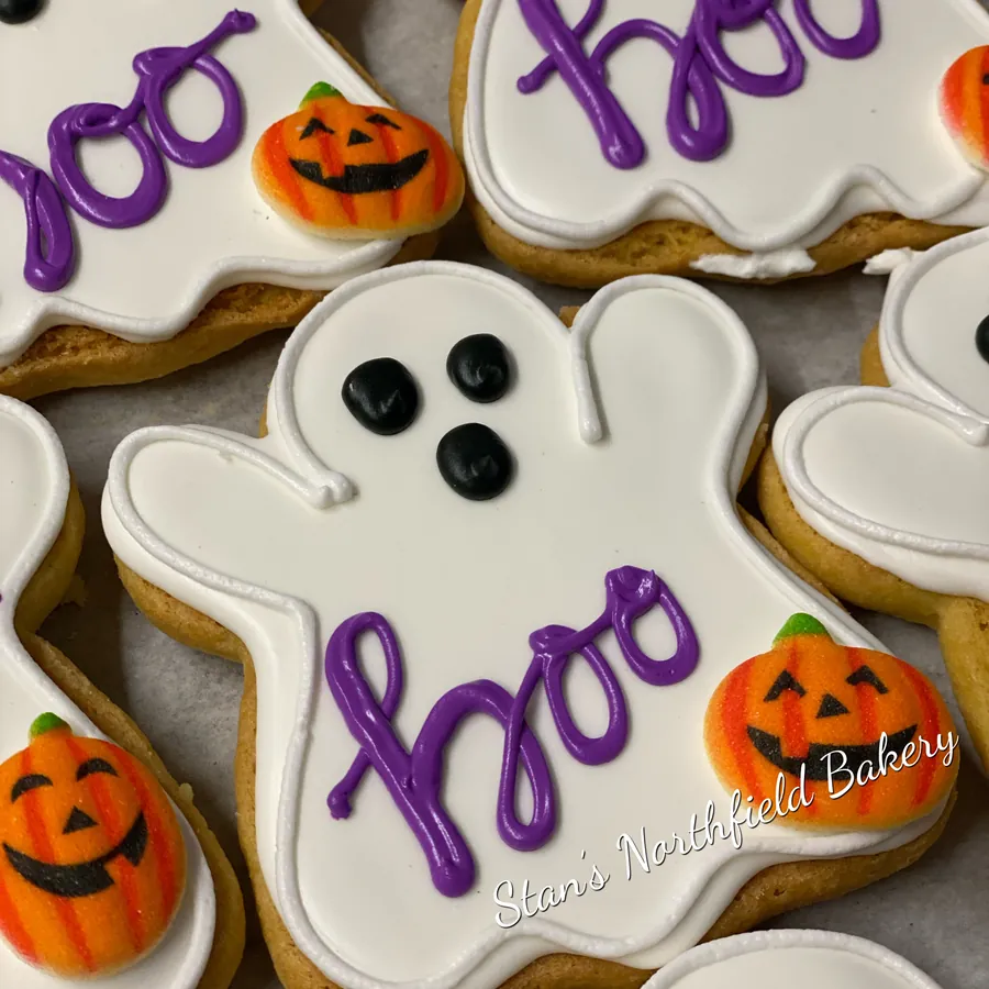 Ghost cookies that say boo, with jack-o'-lantern cookies