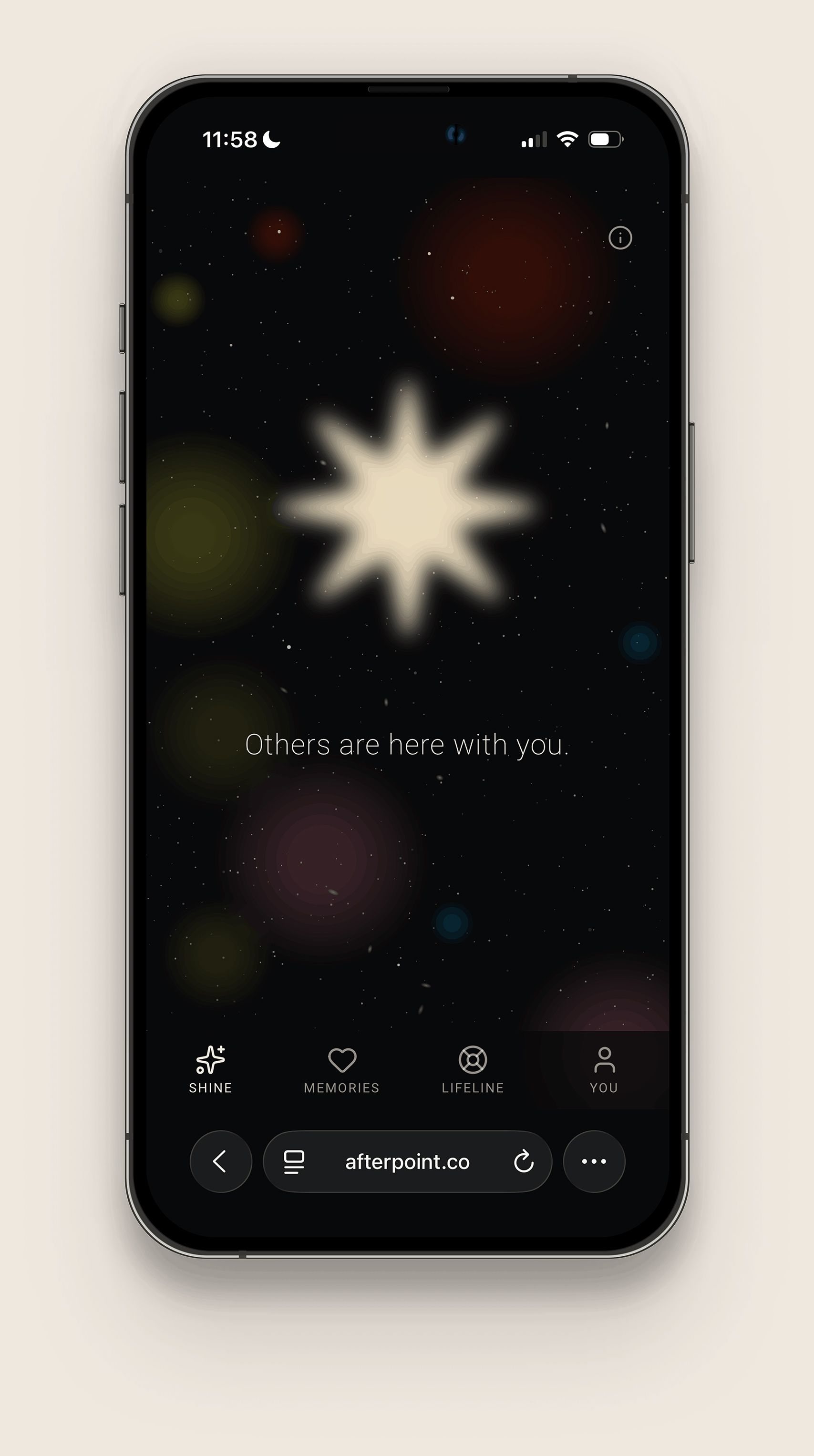 Smartphone screen showing an app interface with a dark space-themed background featuring a large glowing star and smaller colorful circles, with text 'Others are here with you.' Below are four navigation icons labeled Shine, Memories, Lifeline, and You, with the You icon highlighted. The browser bar at the bottom displays the URL afterpoint.co.