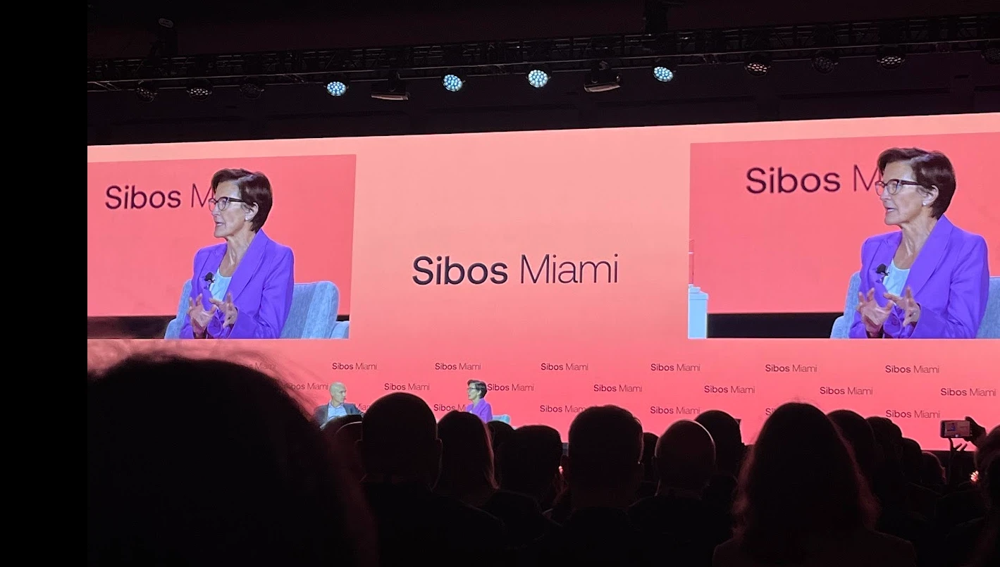 Main-stage fireside conversation shown on the big screens at Sibos 2026 in Miami