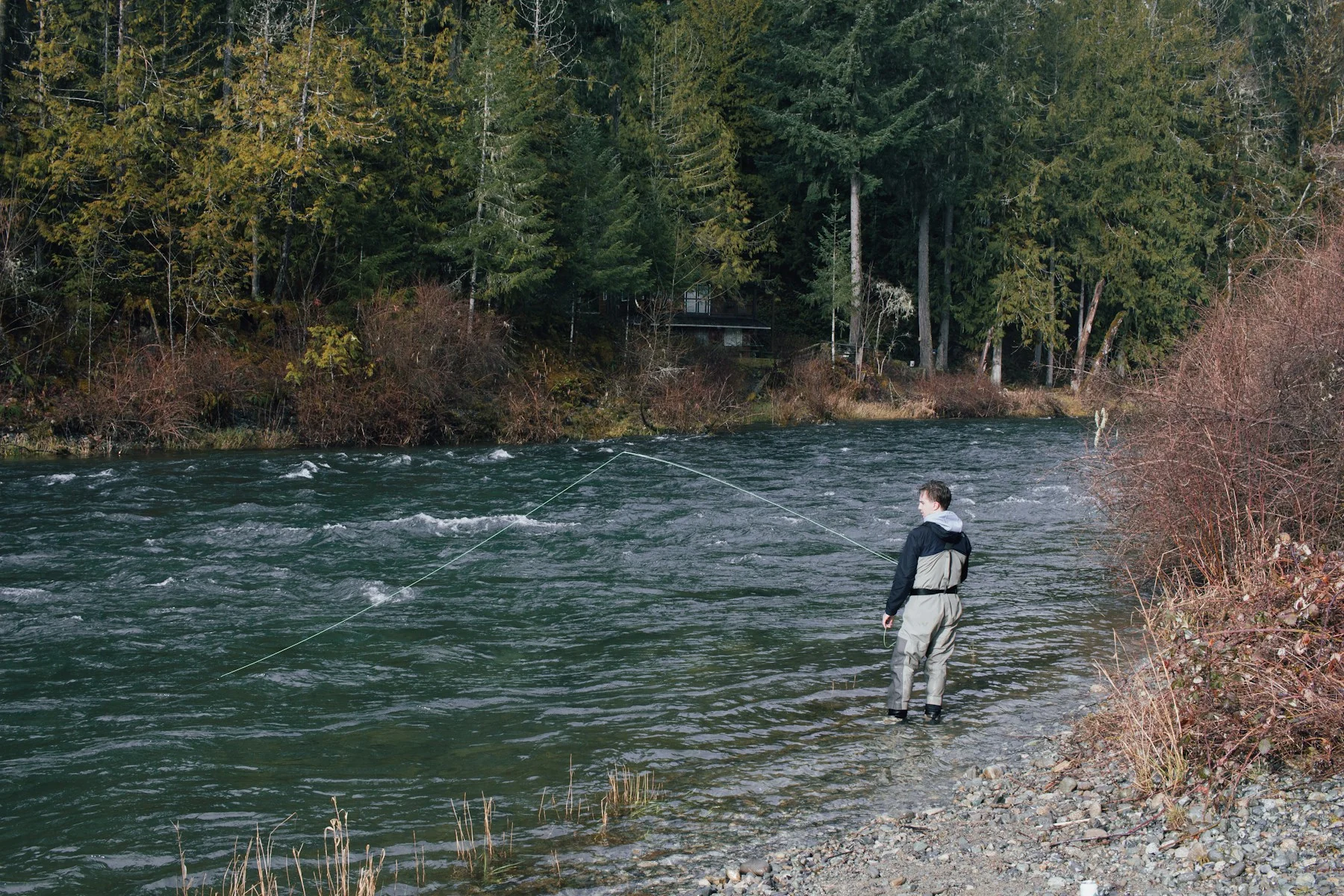 An angler fly fishing the Cowichan River on Vancouver Island
