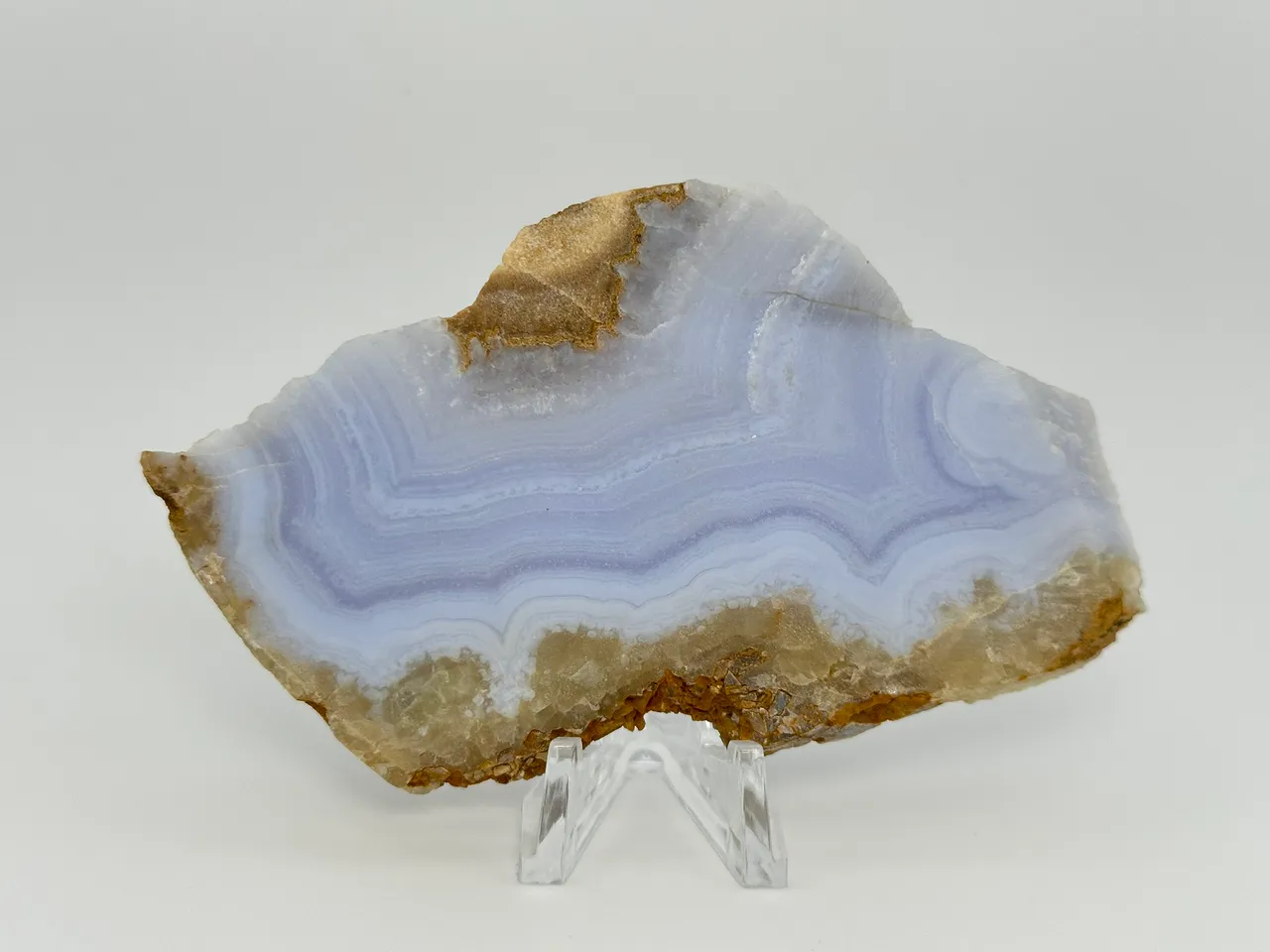 Unpolished blue lace agate slab with pale blue and white bands from Namibia; reference material.