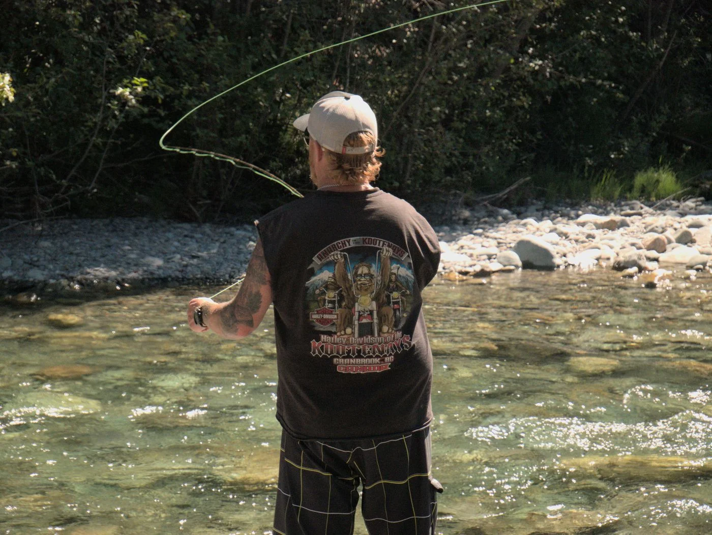 A fly angler in a clear Alberta river, shown as angling inspiration