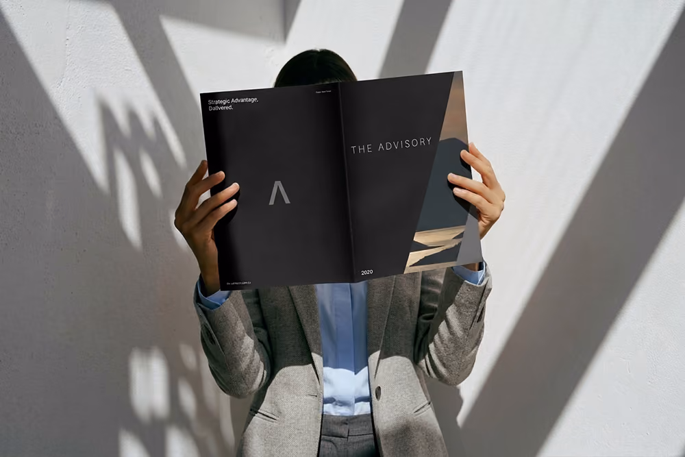 Person holding The Advisory brochure