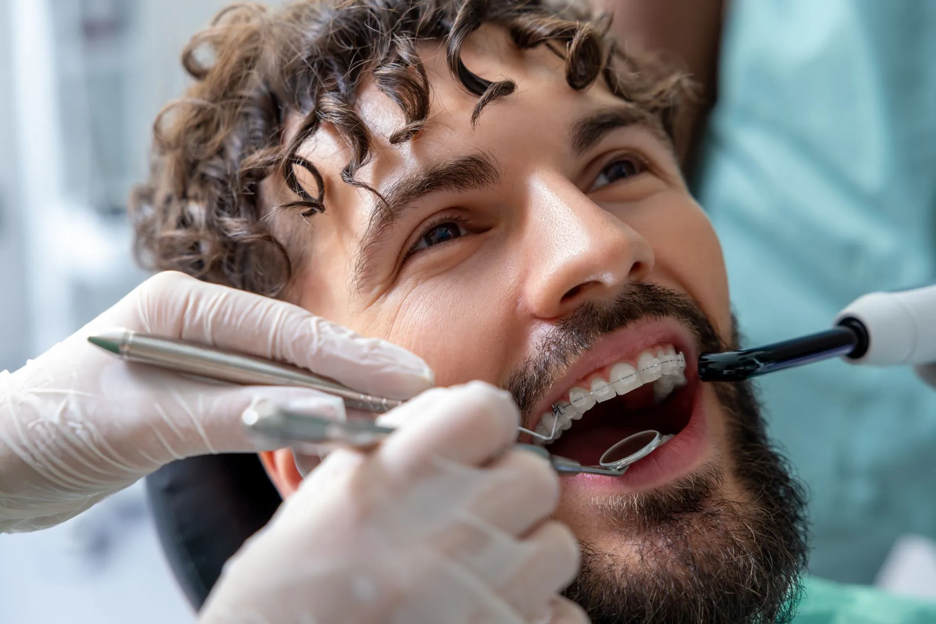 Patient having his teeth examined before getting braces
