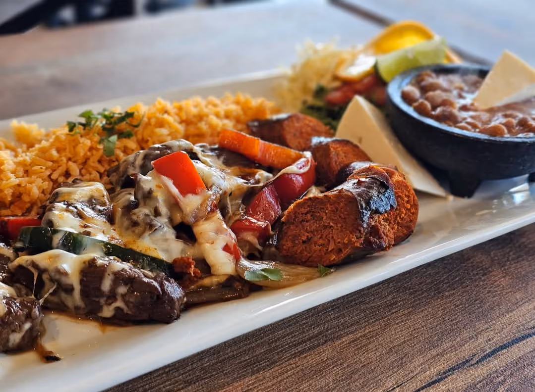 Carne asada plate with melted cheese, chorizo, rice, and beans at Don Chuy's Taqueria