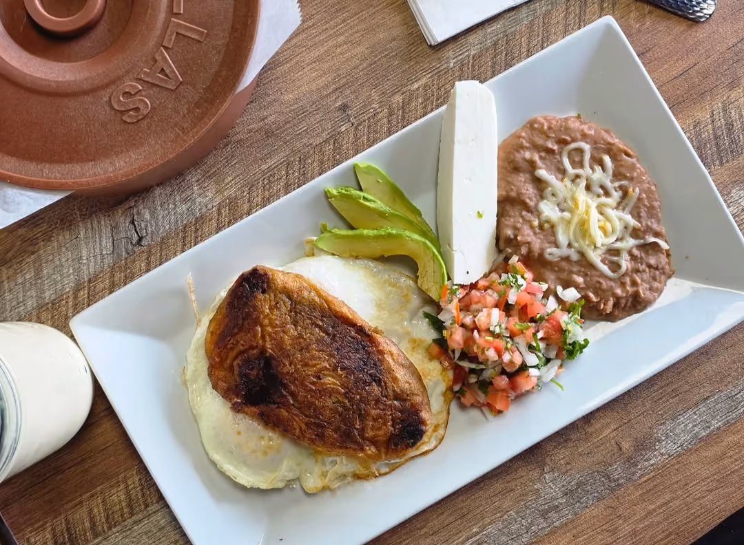 Steak and egg plate with avocado, queso fresco, beans, and pico de gallo at Don Chuy's
