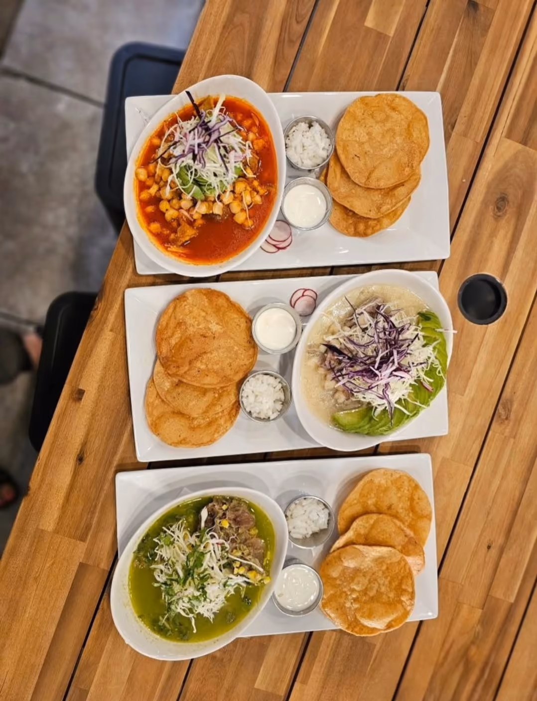 Three bowls of red, white, and green pozole with tostadas at Don Chuy's Taqueria, Burbank IL