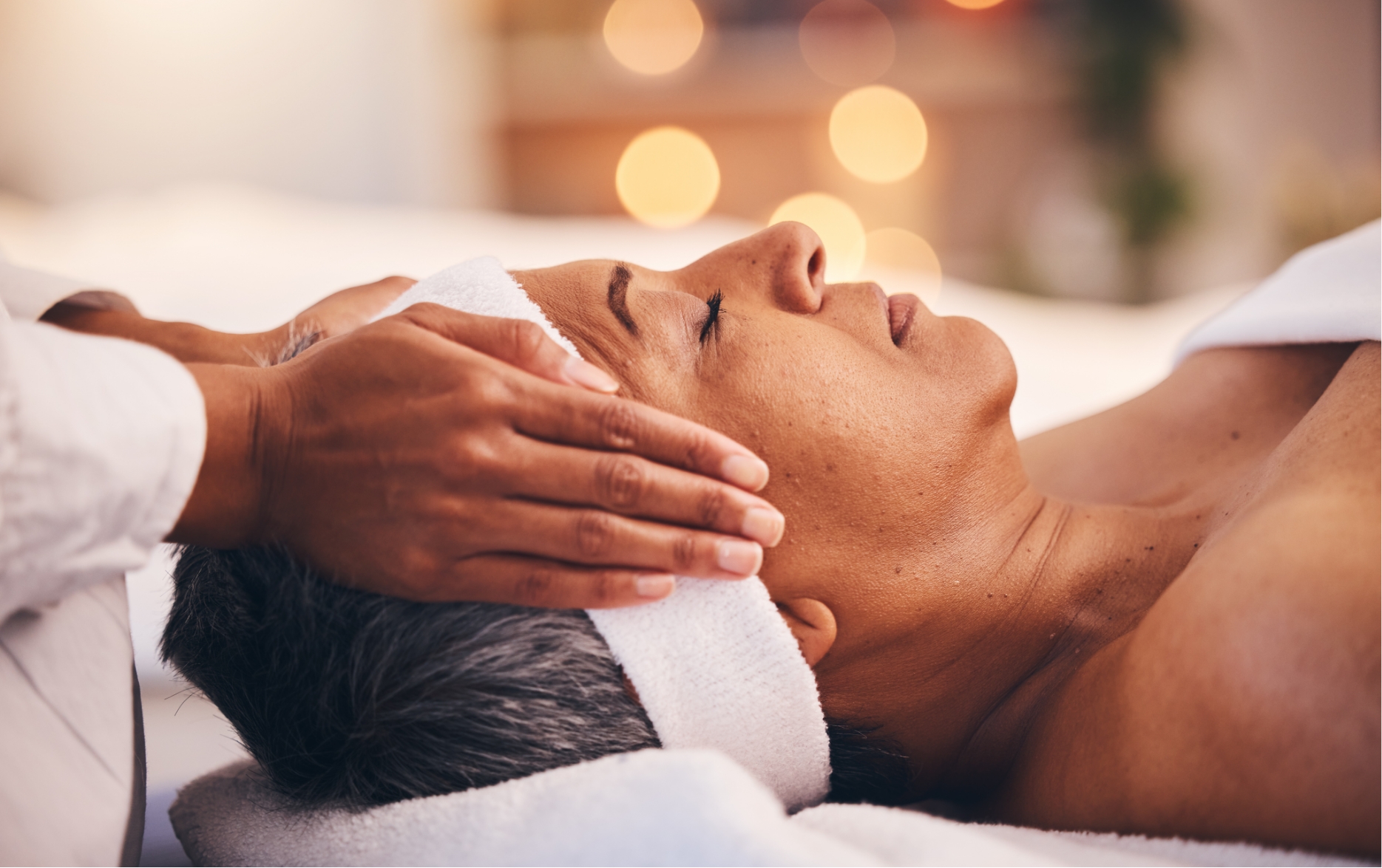 senior receiving a massage and facial