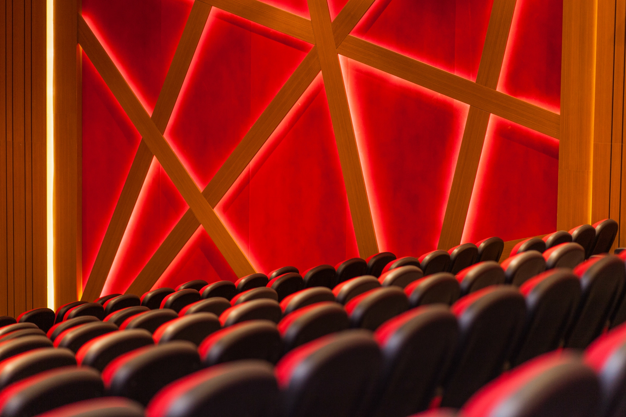 Close-up of a red diamond-pattern acoustic wall panel on a finished project